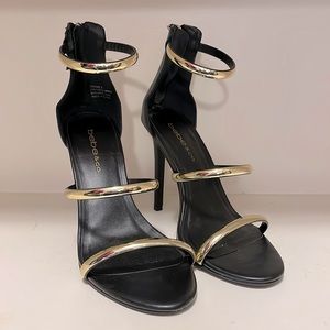 Bebe & Co. gold and black strappy heels
